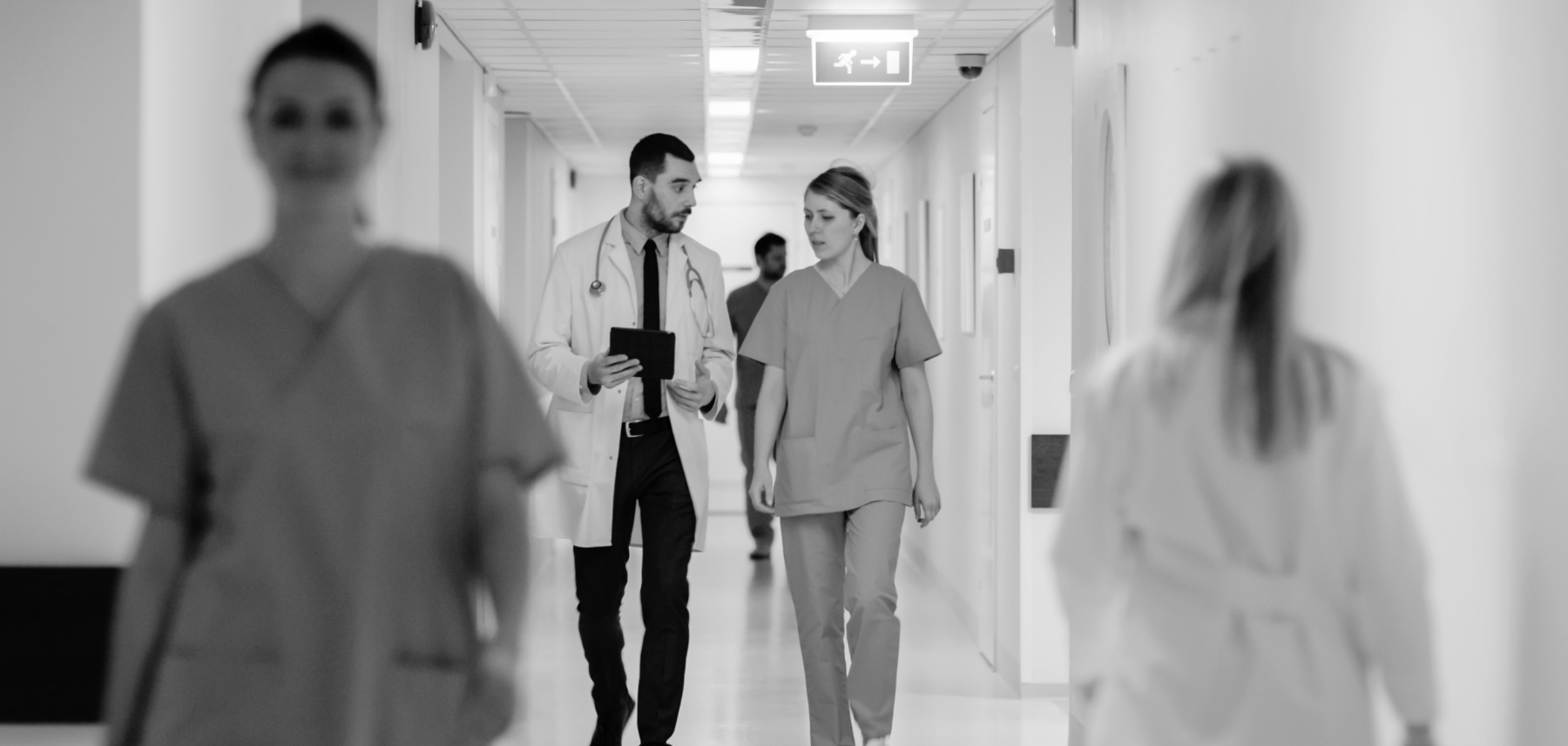 A group of people walking down a hallway.