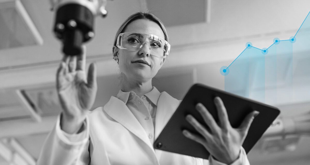 Scientist holding digital tablet while adjusting medical equipment